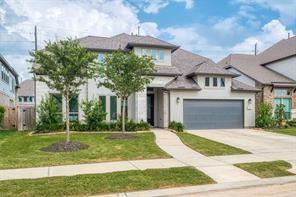 view of front of property with a garage and a front yard