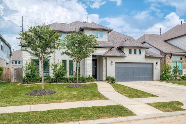 view of front of property featuring a shingled roof, a front yard, driveway, and stucco siding