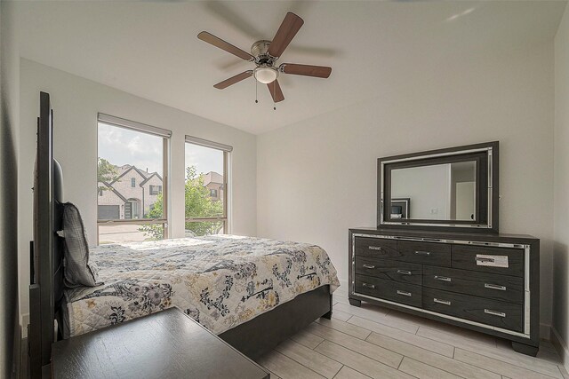 bedroom featuring a ceiling fan and wood tiled floor