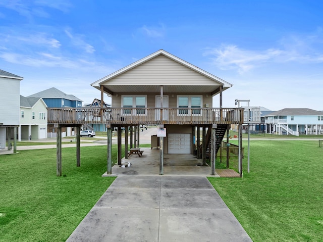 view of front of house featuring stairway, driveway, an attached garage, and a front yard