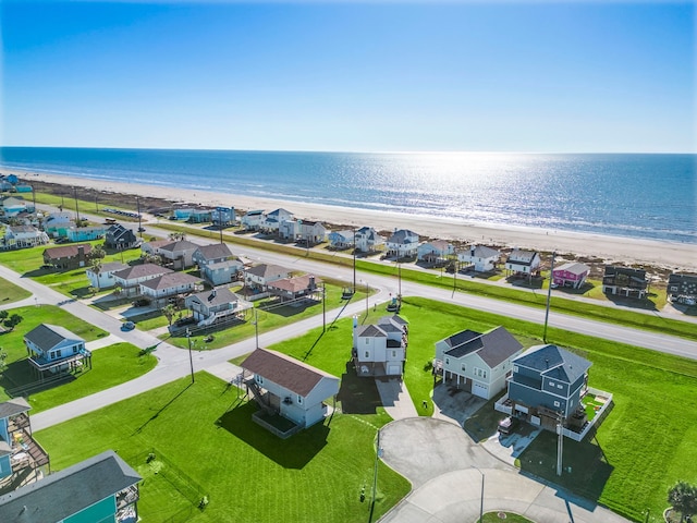 birds eye view of property with a residential view, a water view, and a view of the beach