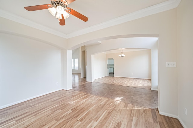 empty room with crown molding, ceiling fan with notable chandelier, and light hardwood / wood-style floors