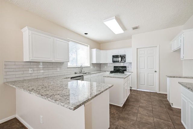 kitchen with white cabinets, light stone countertops, and stove