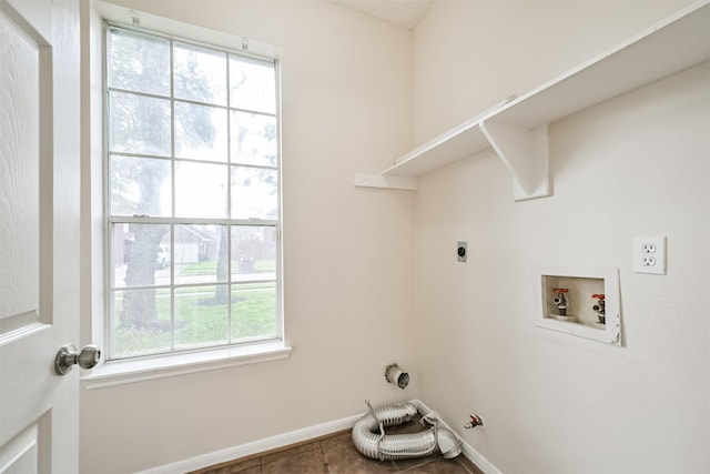 washroom featuring gas dryer hookup, hookup for an electric dryer, tile patterned flooring, and hookup for a washing machine