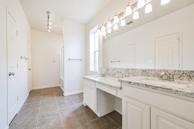 bathroom with tile patterned floors, vanity, rail lighting, and shower / washtub combination