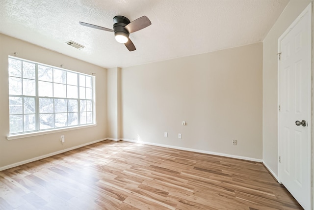 unfurnished room featuring ceiling fan, a textured ceiling, and light hardwood / wood-style floors