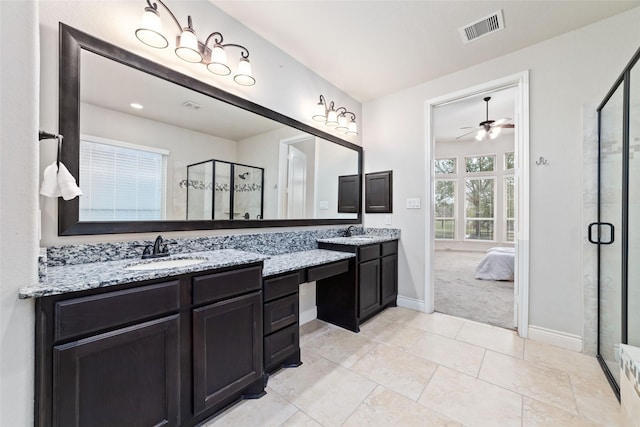 bathroom with a sink, visible vents, ceiling fan, and a shower stall