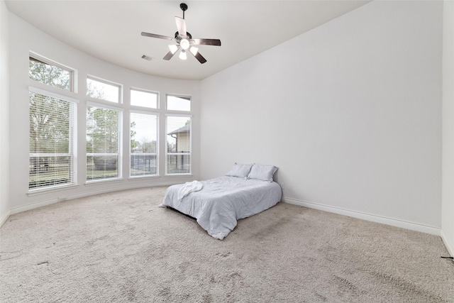 unfurnished bedroom featuring visible vents, baseboards, and carpet floors