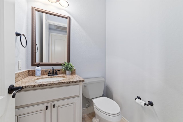 bathroom with toilet and vanity