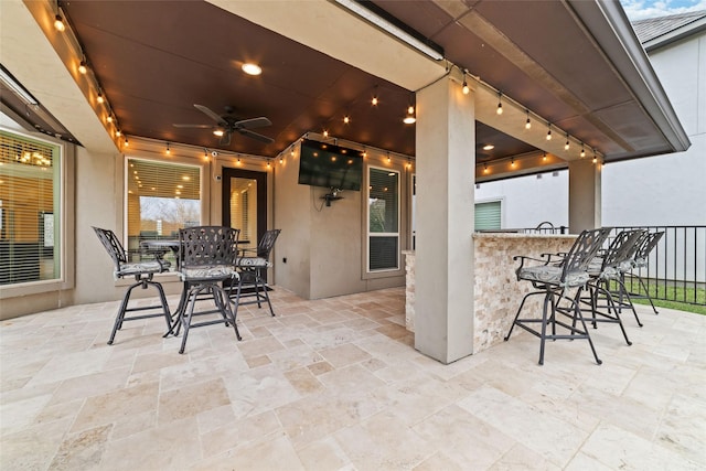 view of patio featuring outdoor dry bar, ceiling fan, and outdoor dining area