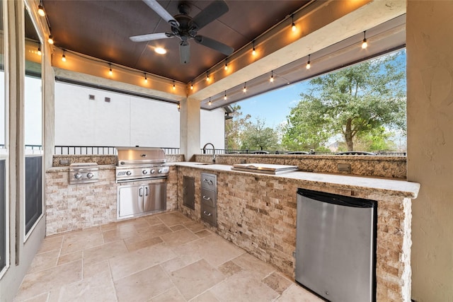view of patio / terrace featuring grilling area, ceiling fan, and exterior kitchen