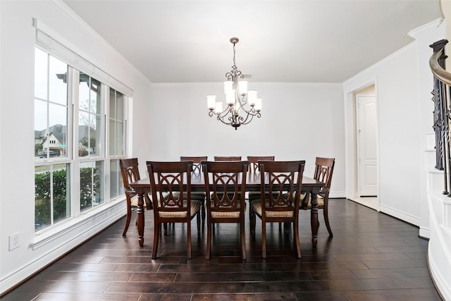 dining area with dark wood-type flooring, ornamental molding, a wealth of natural light, and an inviting chandelier
