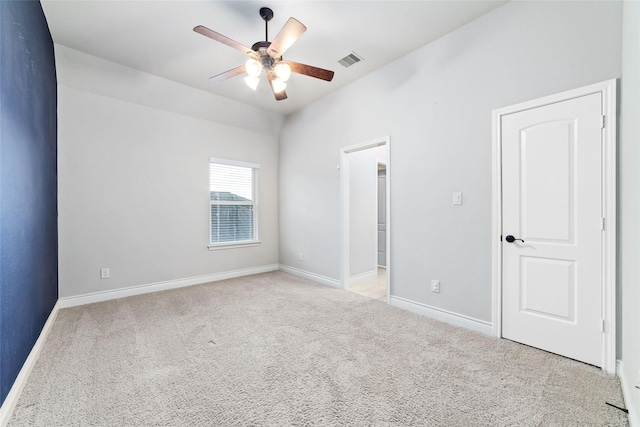 unfurnished bedroom with carpet flooring, visible vents, baseboards, and ceiling fan