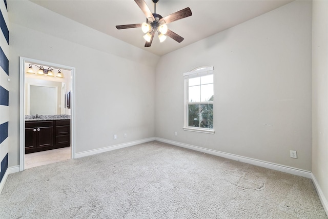 unfurnished bedroom featuring ensuite bathroom, light colored carpet, and baseboards