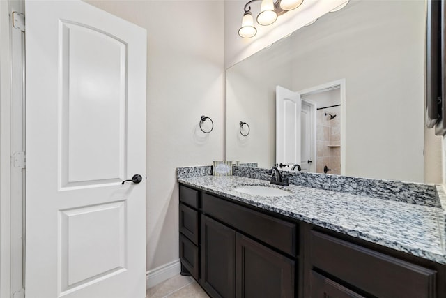 bathroom featuring tile patterned floors, vanity, and baseboards