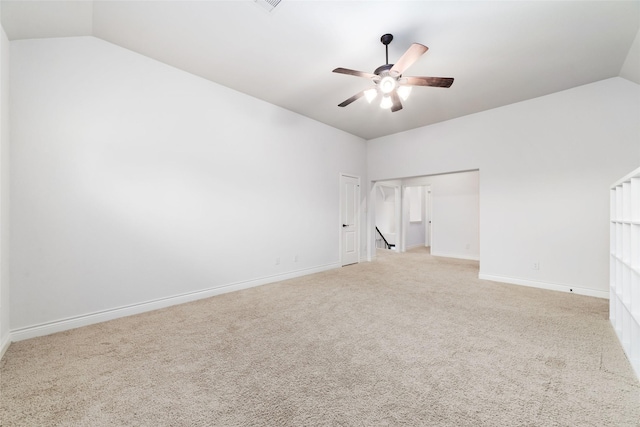 unfurnished room with baseboards, a ceiling fan, light carpet, and lofted ceiling