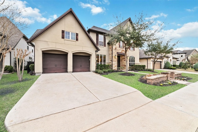 french country home with concrete driveway, a front lawn, a garage, and stucco siding