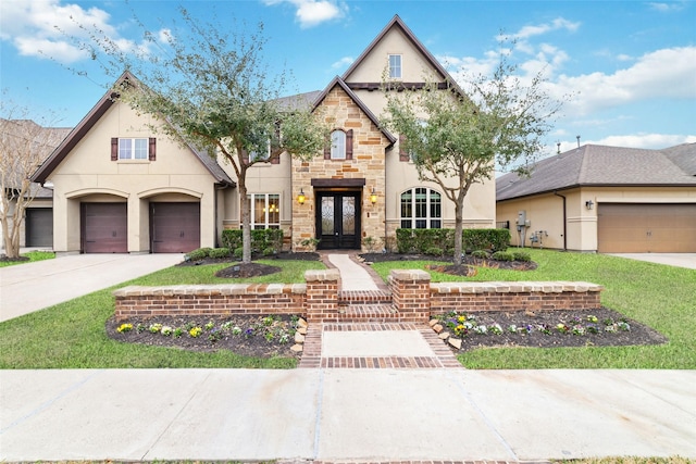 view of front of house with a garage, a front lawn, and french doors