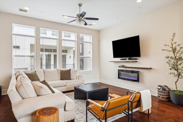 living room featuring dark hardwood / wood-style flooring and ceiling fan