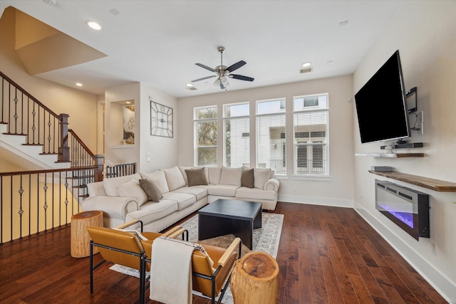 living room featuring ceiling fan and dark hardwood / wood-style floors