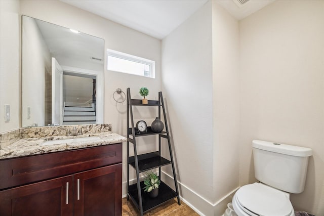 bathroom featuring vanity and toilet