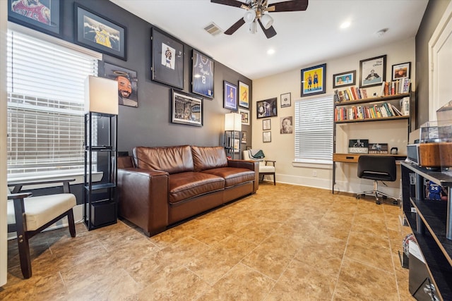 tiled living room with ceiling fan