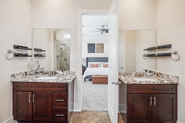 bathroom featuring vanity, a shower with shower door, and ceiling fan