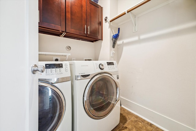 laundry area with cabinets and washer and clothes dryer