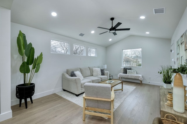 living room featuring lofted ceiling, light hardwood / wood-style flooring, and ceiling fan