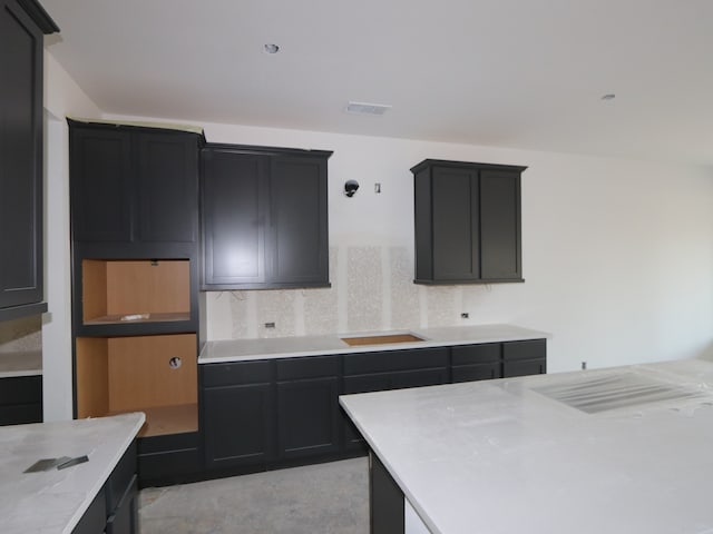 8626 Sun Coral Dr, Cypress, TX 77433 - kitchen with decorative backsplash, dark cabinetry, and light countertops