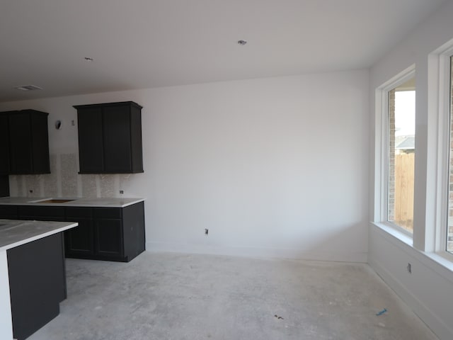 8626 Sun Coral Dr, Cypress, TX 77433 - kitchen featuring healthy amount of natural light, dark cabinets, and baseboards