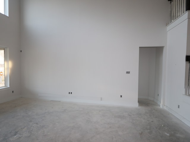 8626 Sun Coral Dr, Cypress, TX 77433 - unfurnished room featuring unfinished concrete flooring and a towering ceiling