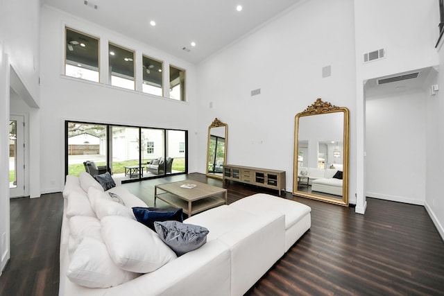 living area featuring visible vents, baseboards, dark wood finished floors, and recessed lighting