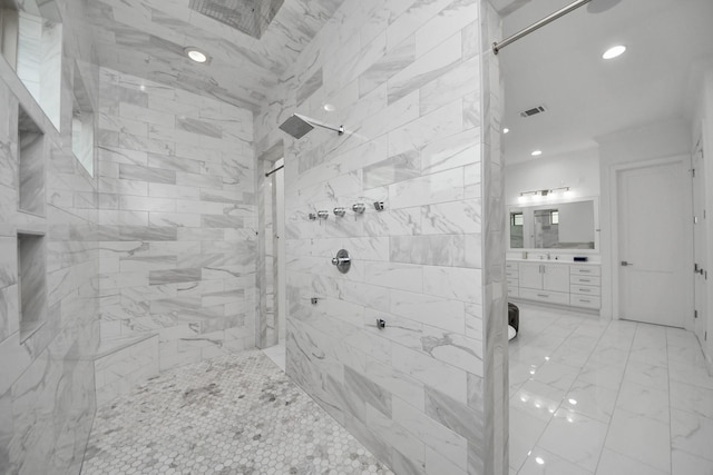 full bath featuring recessed lighting, vanity, visible vents, marble finish floor, and tiled shower