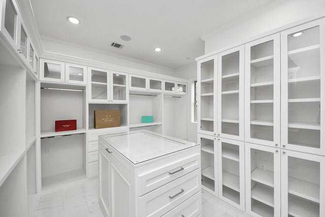 walk in closet with marble finish floor and visible vents