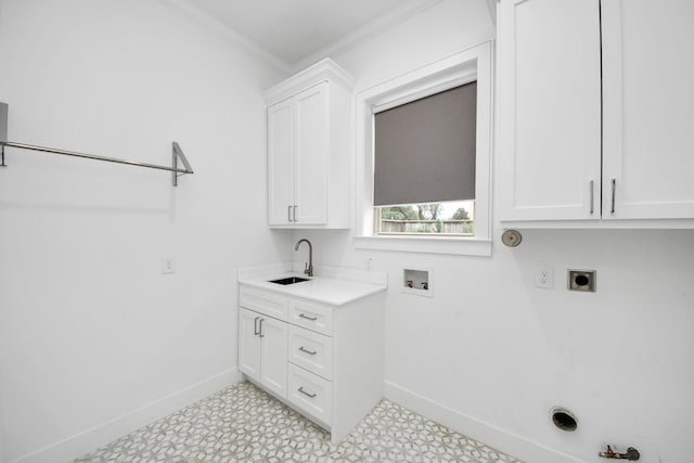 washroom with cabinet space, a sink, gas dryer hookup, electric dryer hookup, and baseboards