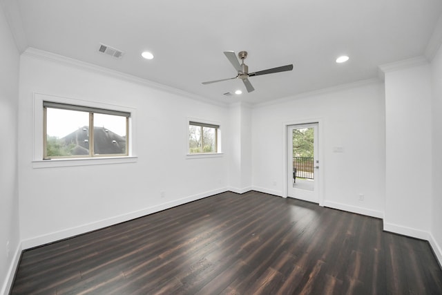 unfurnished room featuring baseboards, dark wood-style floors, visible vents, and crown molding