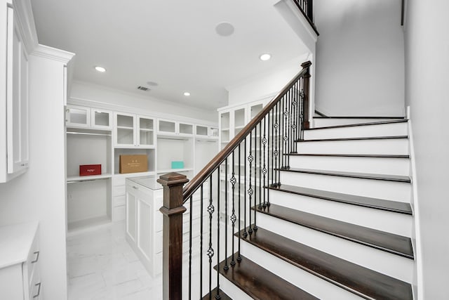 staircase with ornamental molding, recessed lighting, marble finish floor, and visible vents