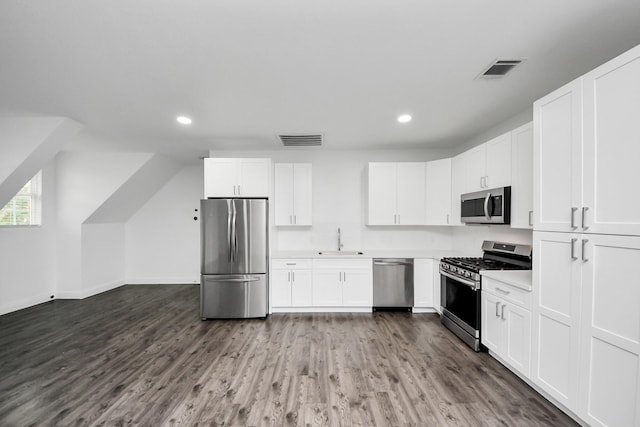 kitchen with visible vents, appliances with stainless steel finishes, a sink, and white cabinetry