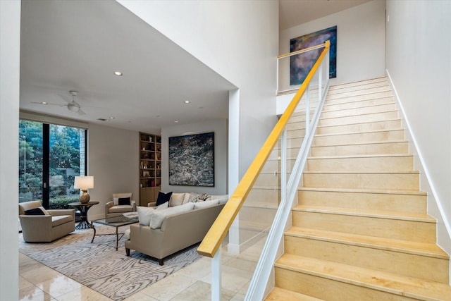 stairway featuring built in shelves, tile patterned floors, and ceiling fan