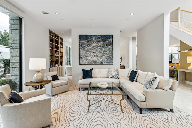 living room with light tile patterned floors and built in features