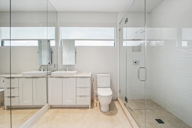 bathroom with vanity, a shower with shower door, and toilet