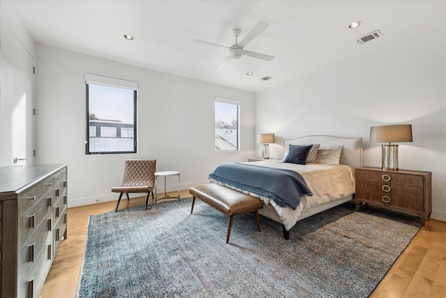 bedroom with ceiling fan and light hardwood / wood-style floors