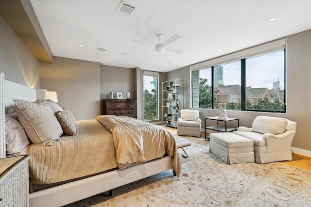 bedroom with ceiling fan and light hardwood / wood-style floors