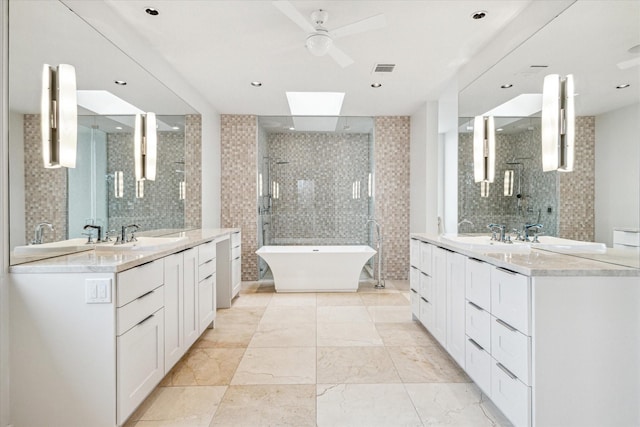 bathroom featuring ceiling fan, vanity, plus walk in shower, and tile walls