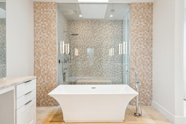 bathroom featuring vanity, tile patterned floors, tile walls, and separate shower and tub