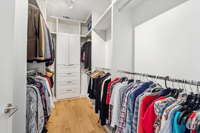 spacious closet with light hardwood / wood-style floors