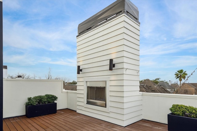 wooden terrace with exterior fireplace