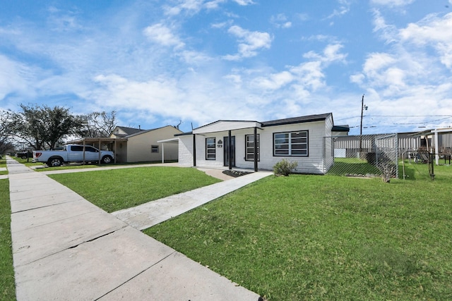 view of front of home with driveway and a front lawn