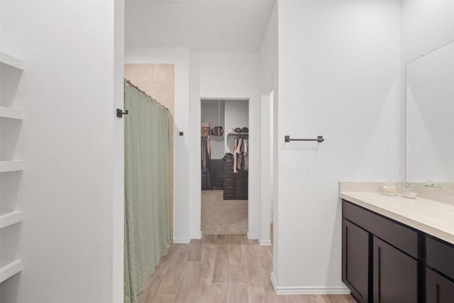 bathroom with vanity, wood-type flooring, and a shower with shower curtain